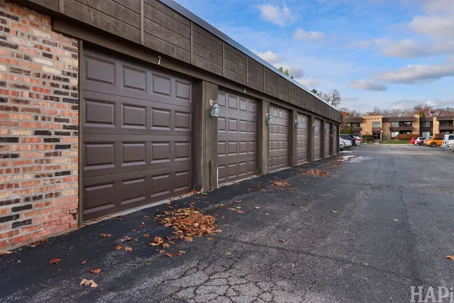 a view of a house with backyard and wooden fence