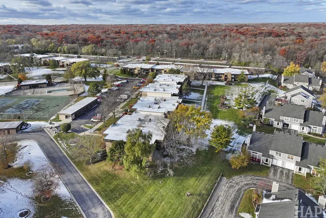 an aerial view of a house with a garden and lake view