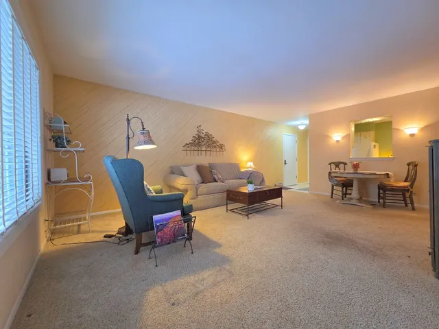 a living room with furniture and a pool table