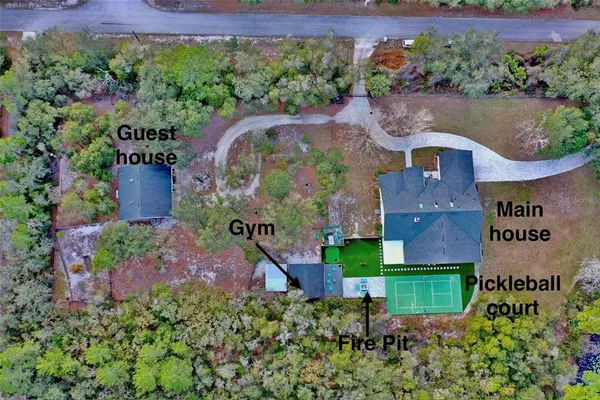 an aerial view of a house with a yard and garden