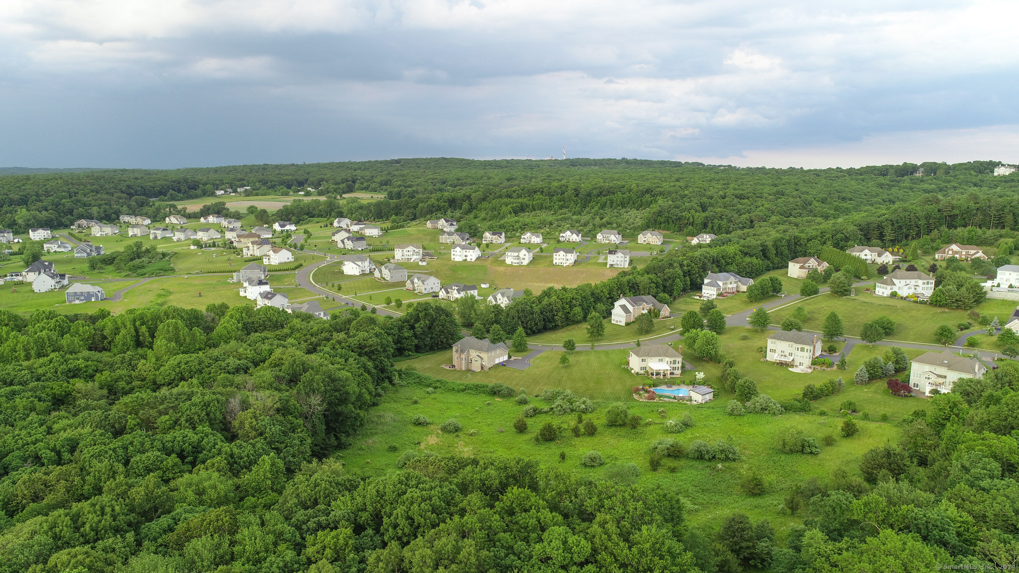 390 Ash Swamp Road Glastonbury, CT 06033 - Photo 6 of 10 an aerial view of residential houses with outdoor space and trees