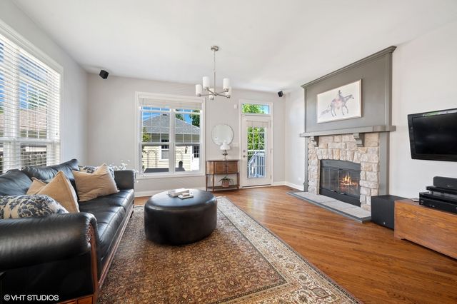 a living room with furniture a window and a fireplace