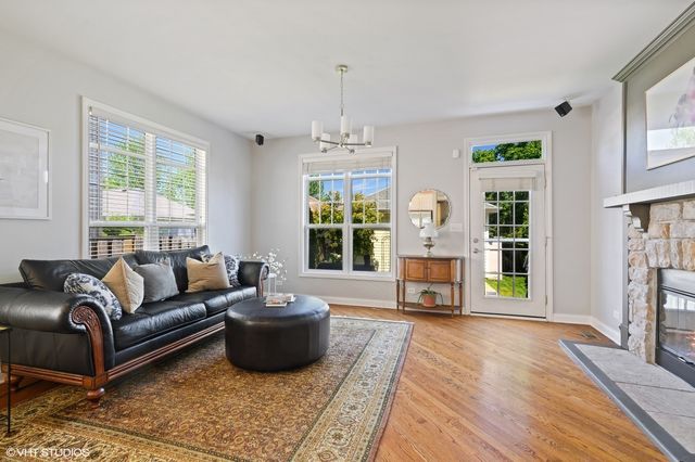 a living room with furniture large window and fireplace