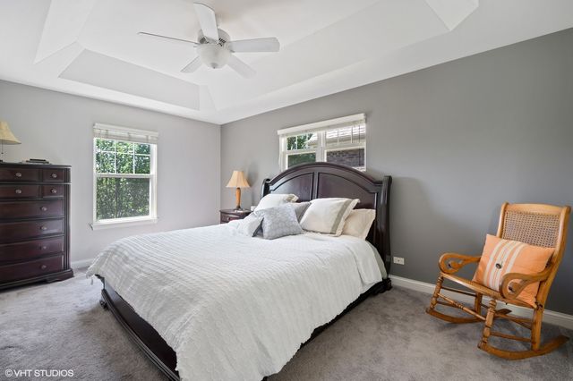 a bedroom with a bed chair and window