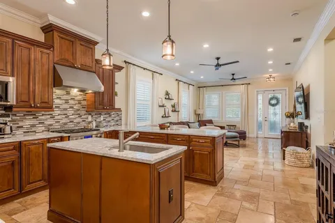 a kitchen with a sink counter top space and stainless steel appliances