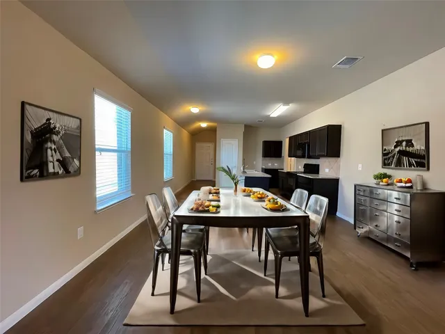a view of a dining room with furniture window and wooden floor