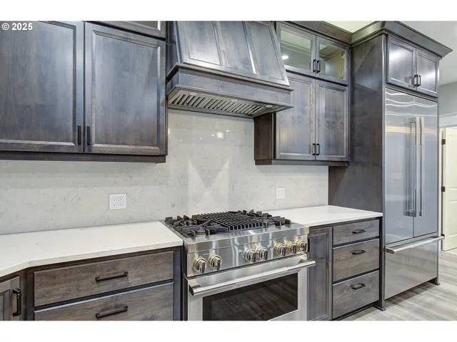 a kitchen with stainless steel appliances a stove and a microwave