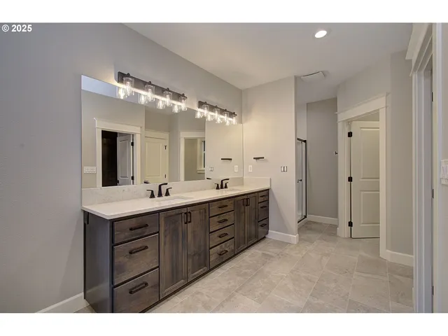 a spacious bathroom with a granite countertop sink mirror and a
