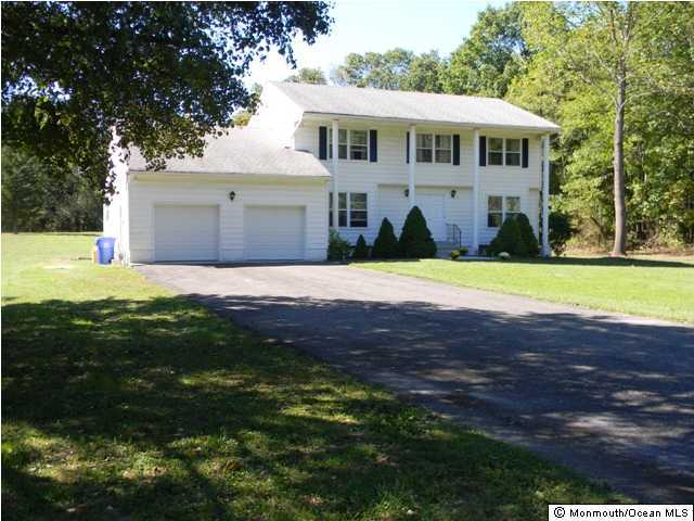 740 Harmony Road Jackson, NJ 08527 - Photo 1 of 3 a front view of a house with a garden