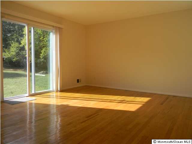 740 Harmony Road Jackson, NJ 08527 - Photo 3 of 3 a view of an empty room with wooden floor and a window