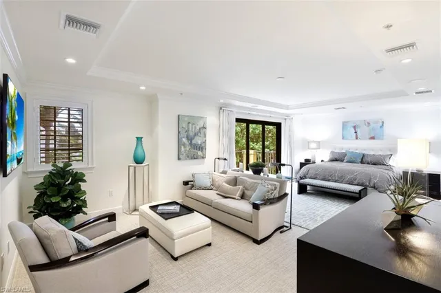 a bedroom with furniture and a large window