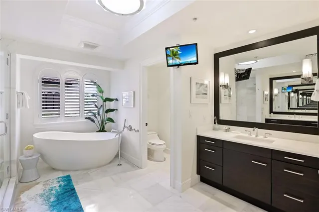 a spacious bathroom with a granite countertop sink and a mirror