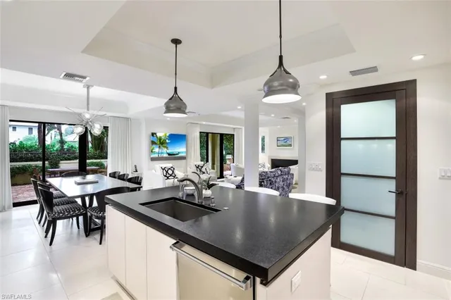 a kitchen with center island table and chairs in it