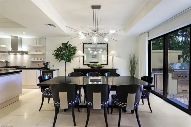 a view of a dining room with furniture and a chandelier