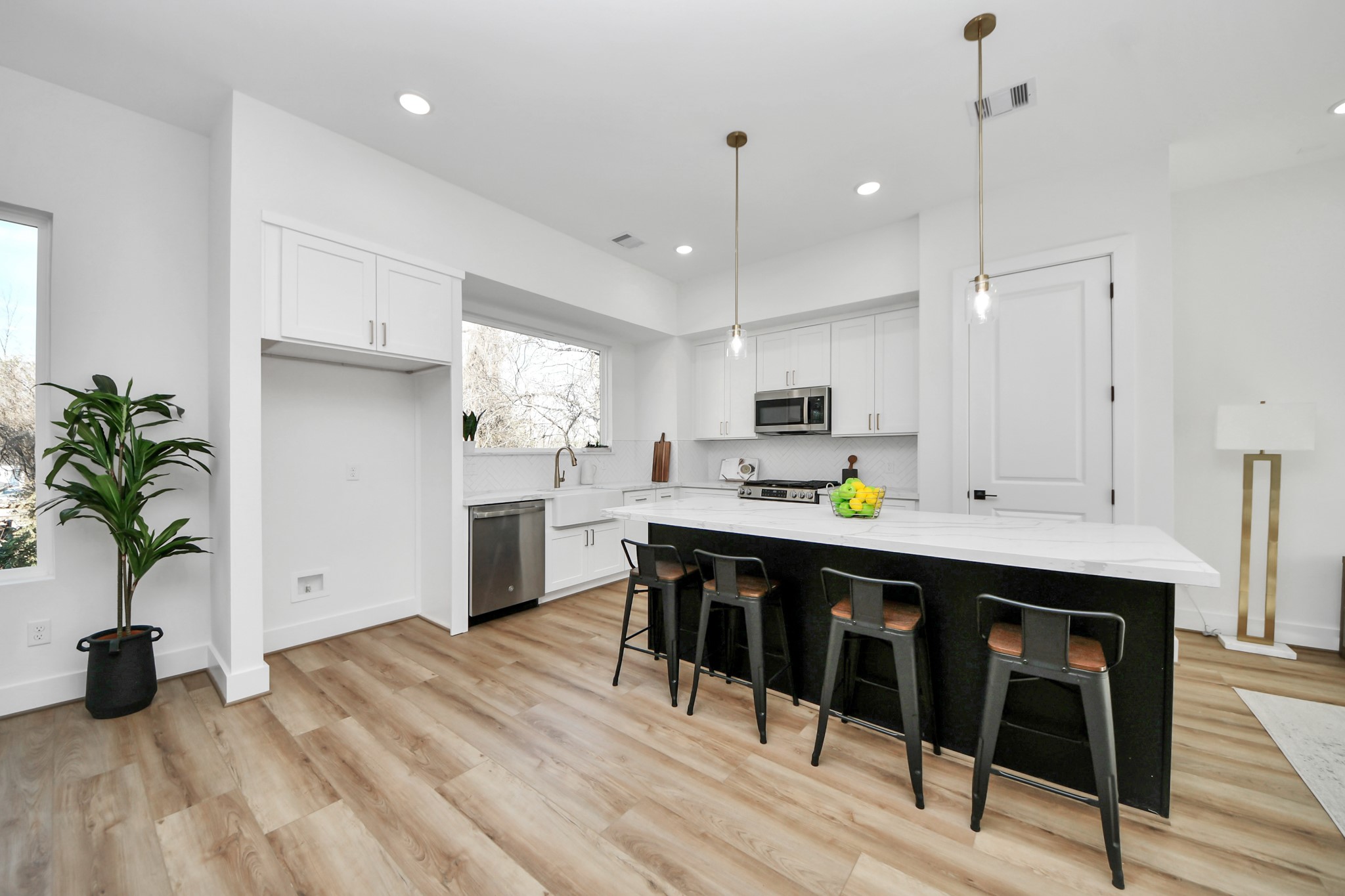4804 Elysian Street, Unit B Houston, TX 77009 - Photo 13 of 49 a kitchen with a table chairs refrigerator and sink