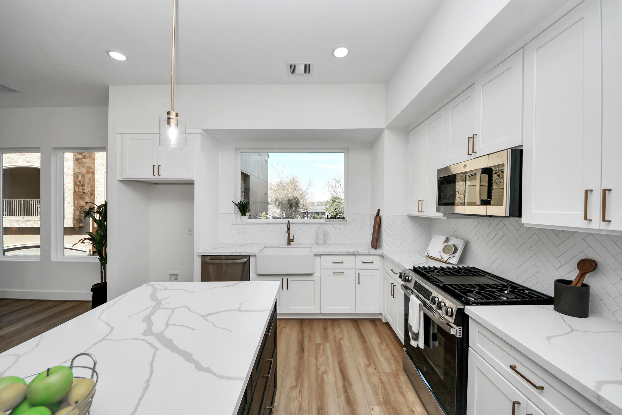 4804 Elysian Street, Unit B Houston, TX 77009 - Photo 16 of 49 a kitchen with stainless steel appliances a stove a sink cabinets and a wooden floor