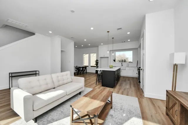 a living room with furniture and a wooden floor