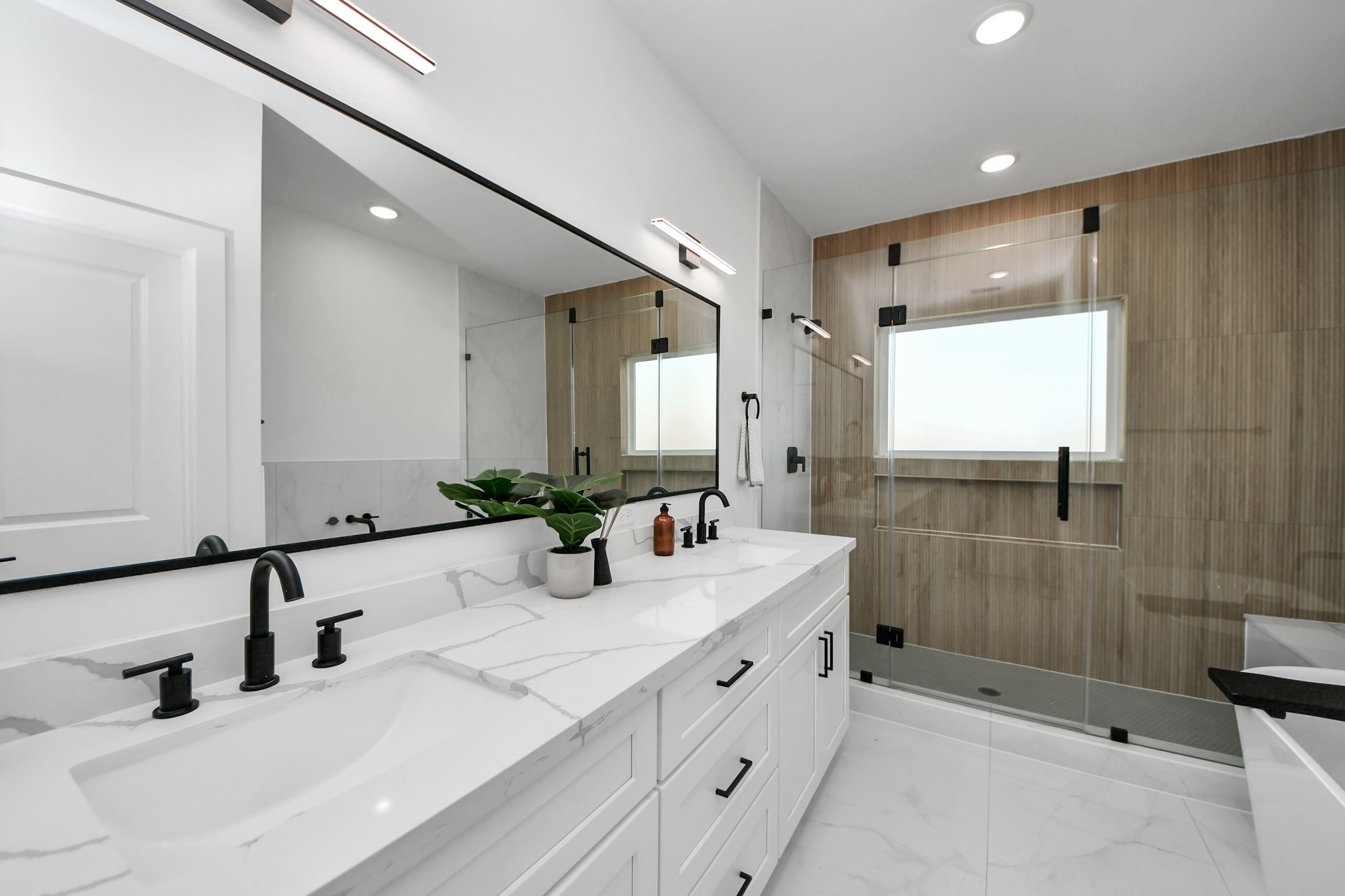 4804 Elysian Street, Unit B Houston, TX 77009 - Photo 31 of 49 a bathroom with a double vanity sink mirror and shower