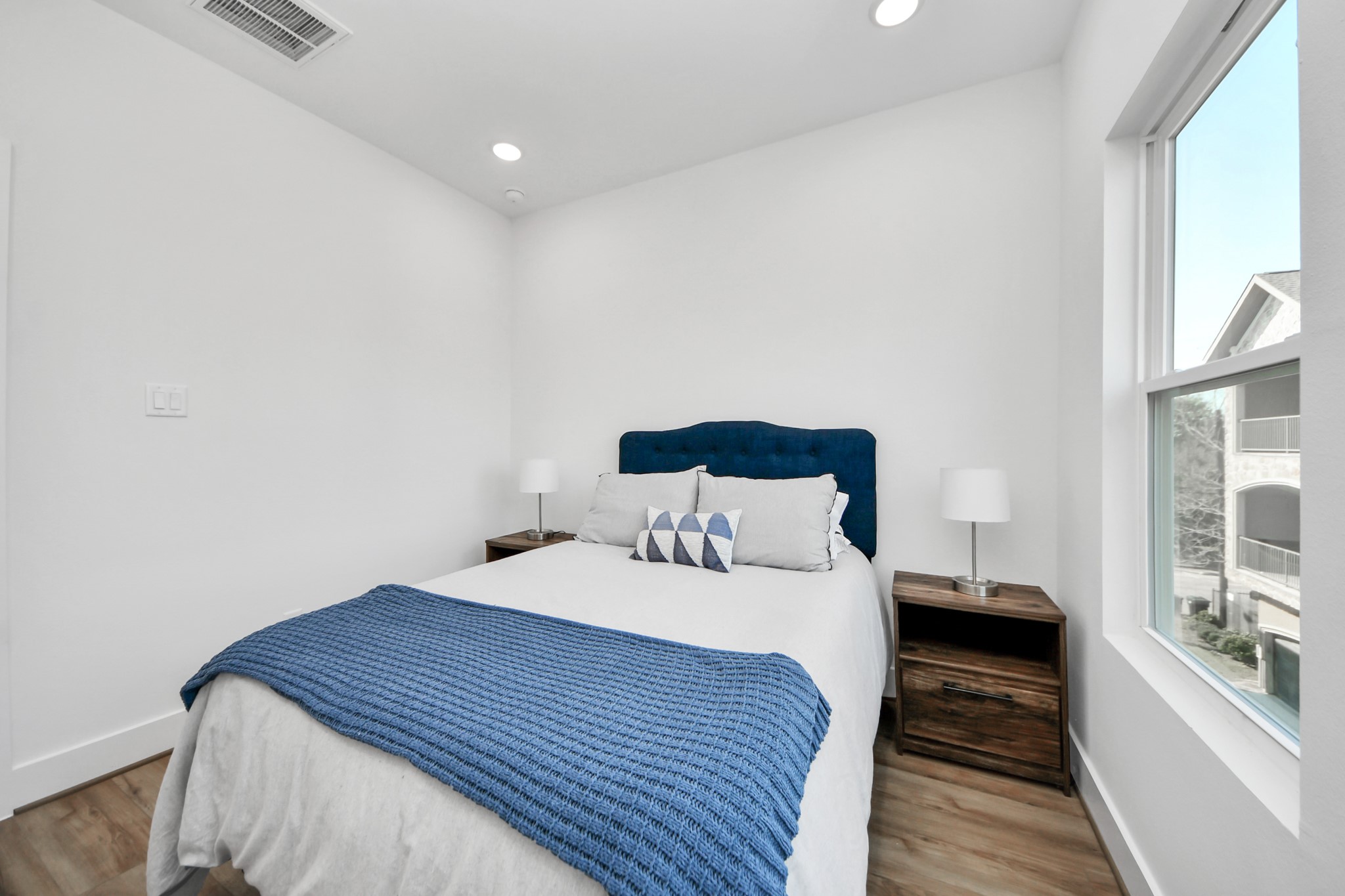 4804 Elysian Street, Unit B Houston, TX 77009 - Photo 36 of 49 a bedroom with a bed and wooden floor