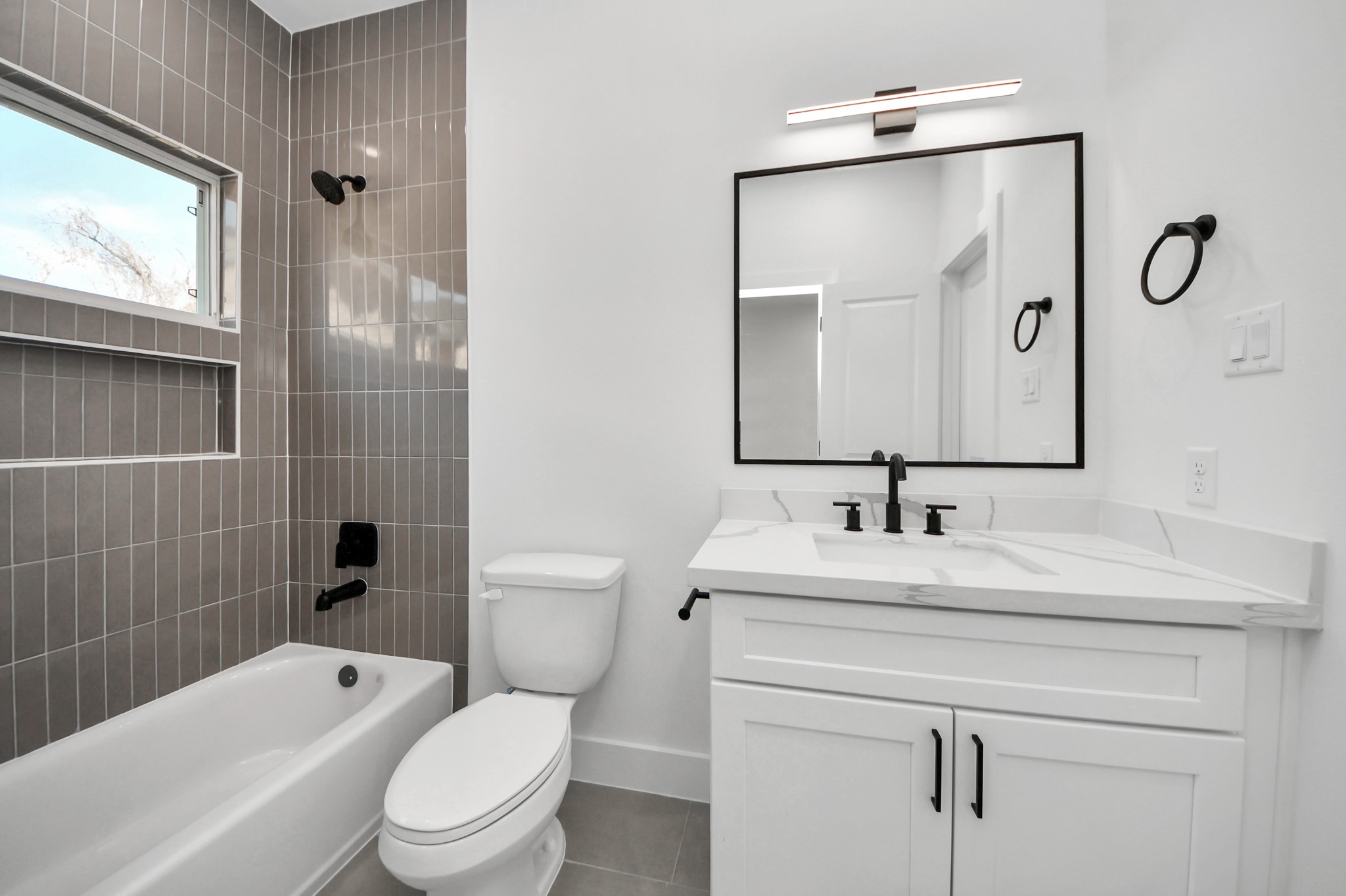4804 Elysian Street, Unit B Houston, TX 77009 - Photo 38 of 49 a bathroom with a toilet sink vanity tub and shower