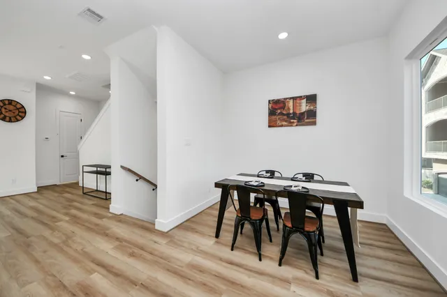 a view of a dining room with furniture and wooden floor