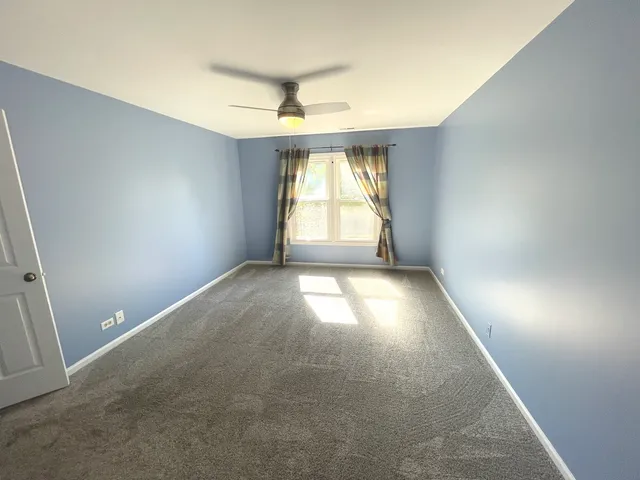 an empty room with a empty space and windows