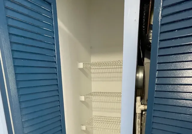 an empty room with windows and bathroom