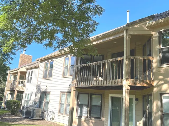 a view of a room with wooden floor and a floor to ceiling window