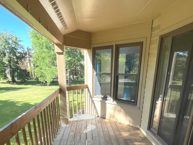 a view of a porch with a floor to ceiling window