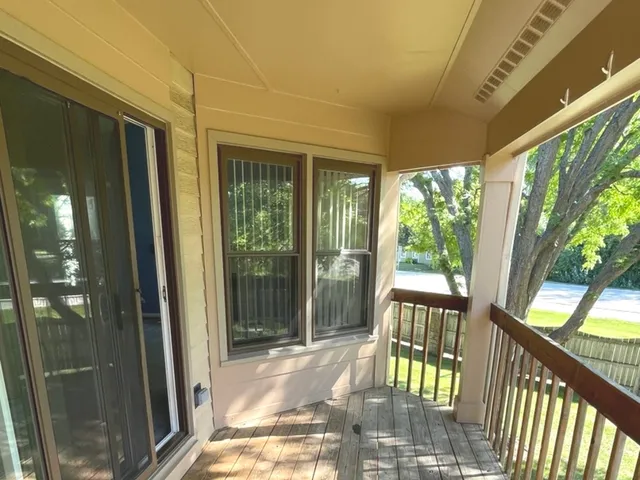 a view of balcony with wooden floor