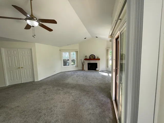 a view of livingroom with a ceiling fan and window