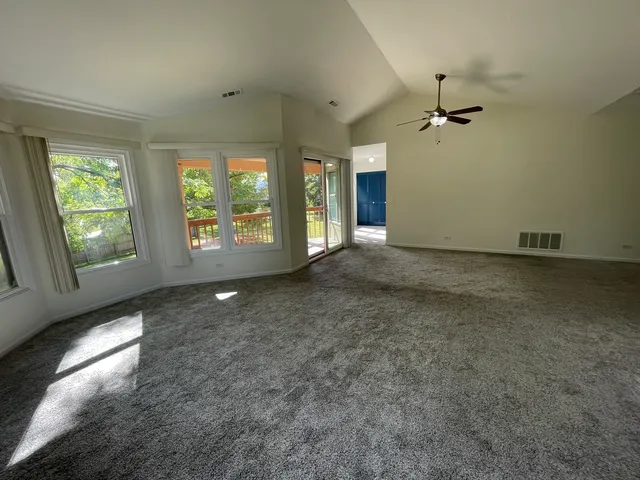 a view of a livingroom with a ceiling fan and window