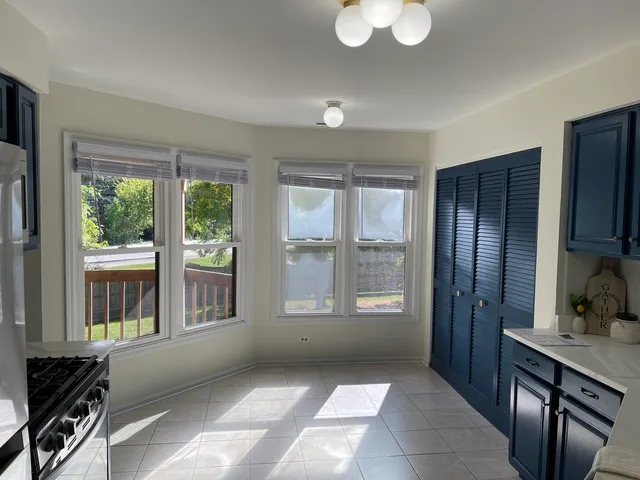 a view of kitchen with windows and refrigerator