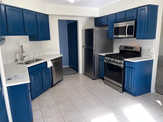 a kitchen with stainless steel appliances granite countertop a refrigerator stove a sink and dishwasher