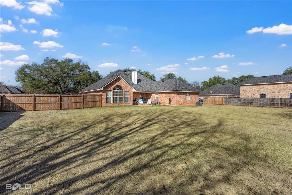218 Ridgefield Drive Bossier City, LA 71111 - Photo 34 of 40 Back of house featuring a fenced backyard, a patio area, and brick siding