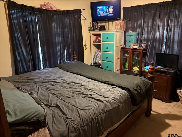 a bedroom with a bed and a bookshelf