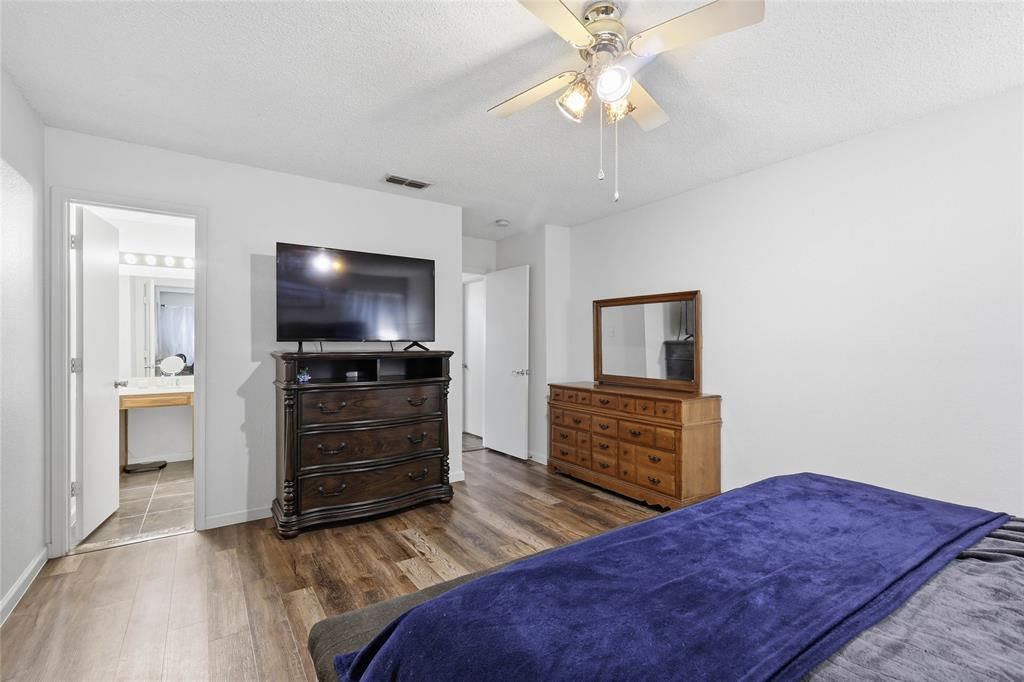 4217 Broken Arrow Road Fort Worth, TX 76137 - Photo 23 of 40 a bedroom with furniture and flat screen tv