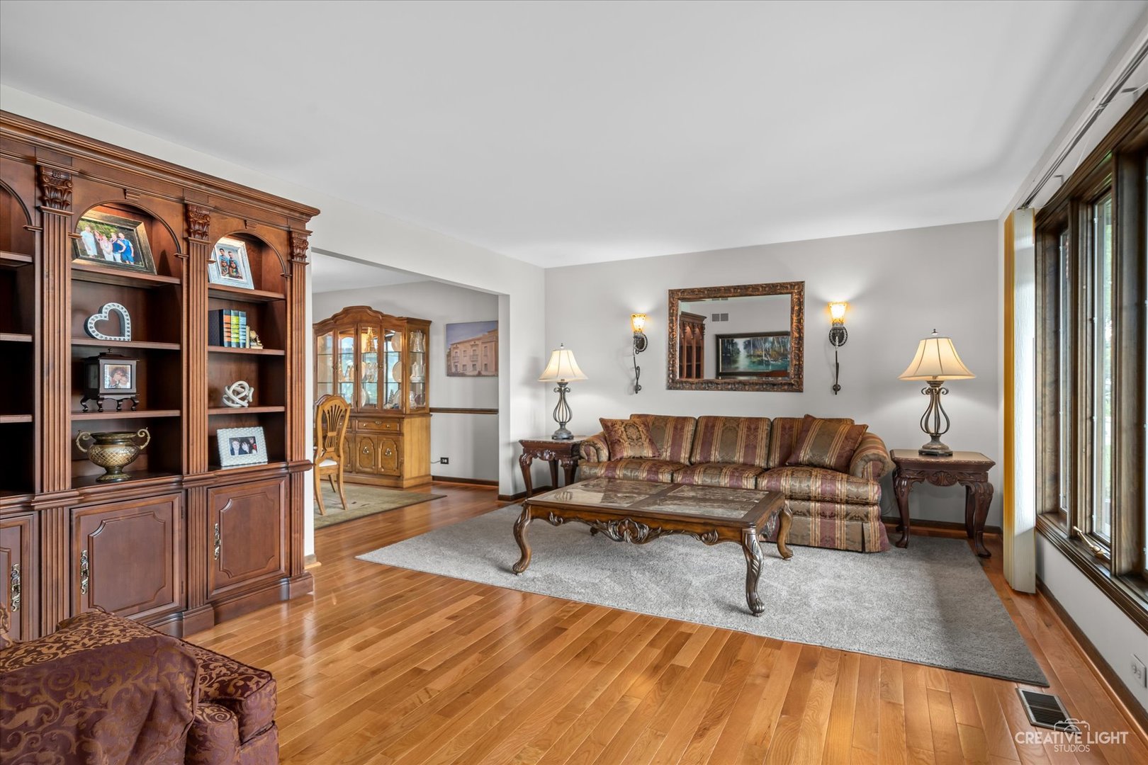 1130 Thatcher Lane Addison, IL 60101 - Photo 12 of 35 a living room with furniture and a book shelf
