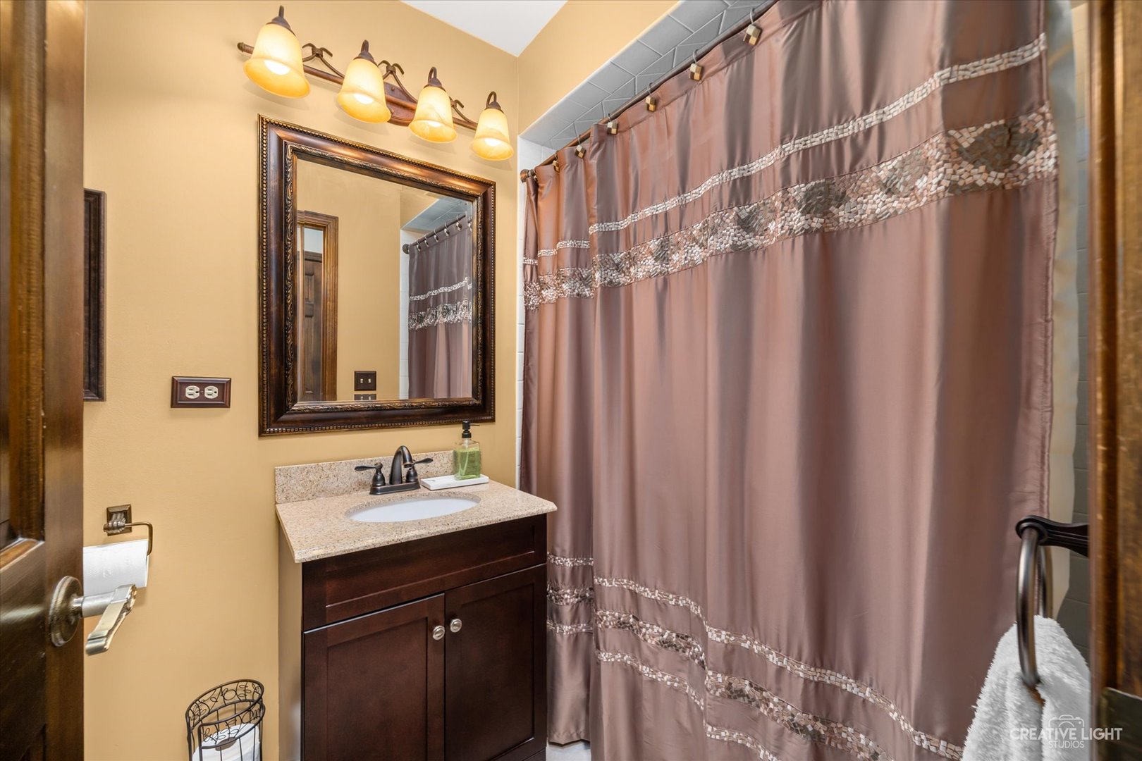 1130 Thatcher Lane Addison, IL 60101 - Photo 20 of 35 a bathroom with a sink a mirror and a shower curtain