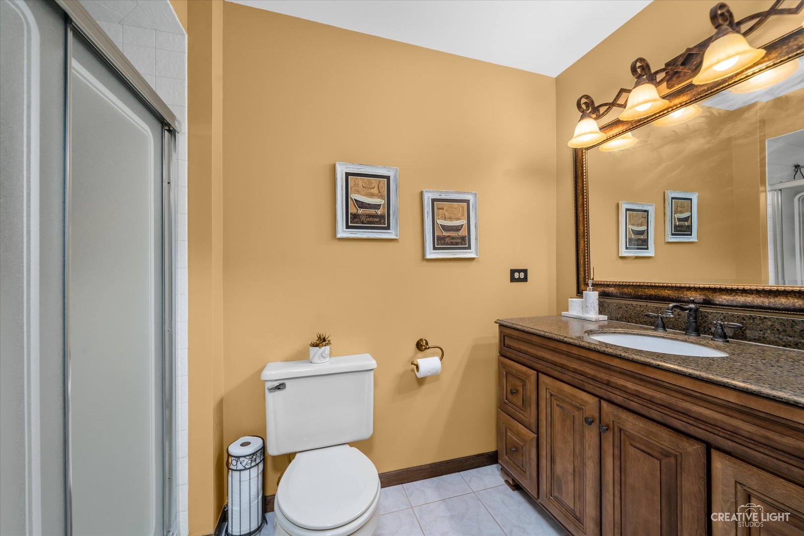 1130 Thatcher Lane Addison, IL 60101 - Photo 21 of 35 a bathroom with a granite countertop toilet sink and mirror