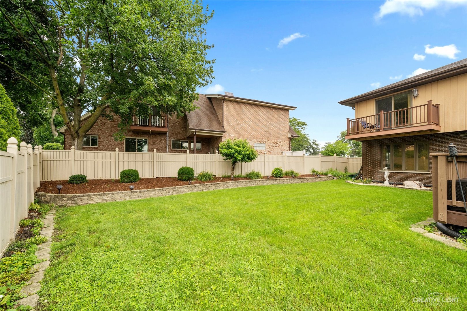 1130 Thatcher Lane Addison, IL 60101 - Photo 29 of 35 a view of a backyard with plants and a patio