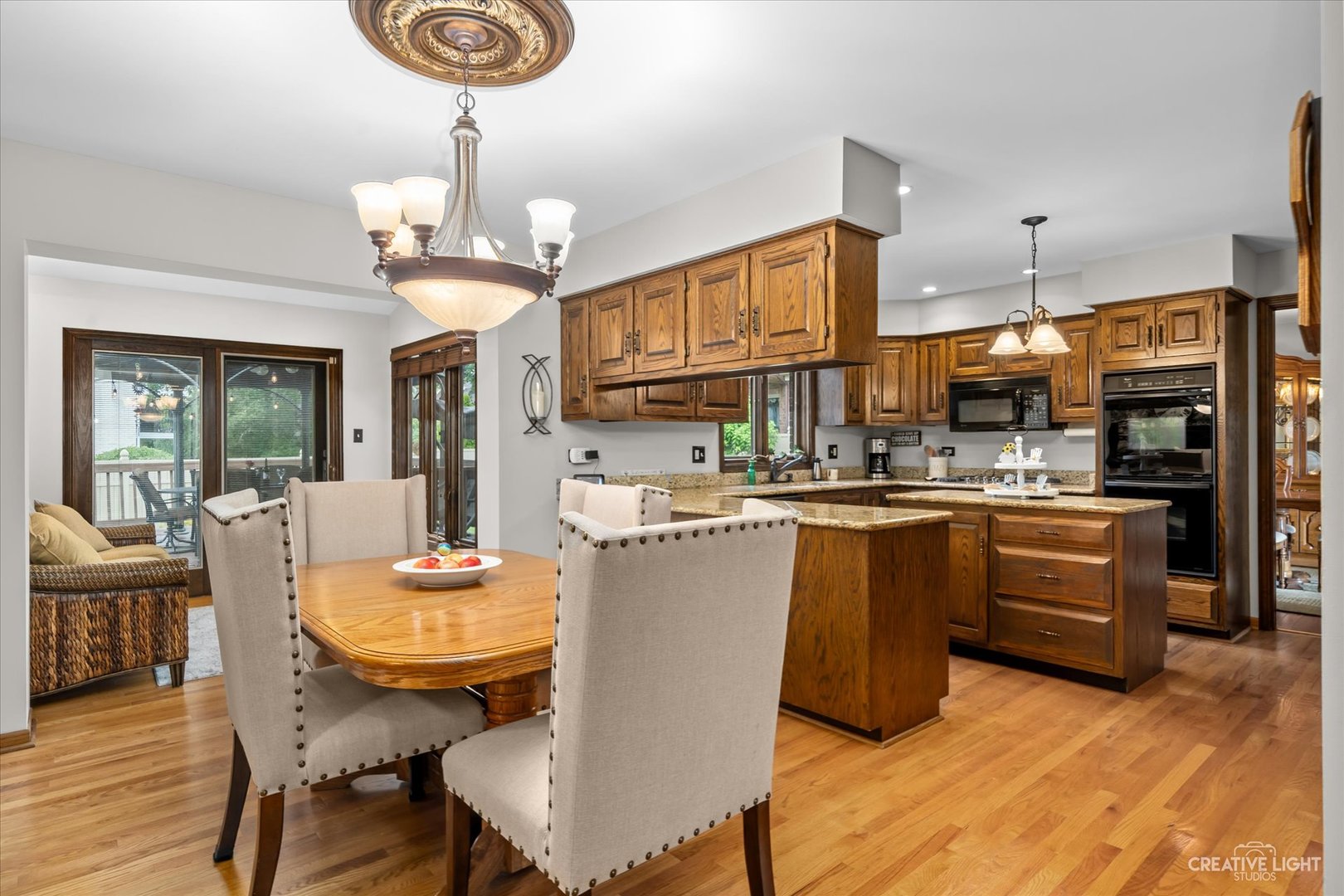 1130 Thatcher Lane Addison, IL 60101 - Photo 3 of 35 a kitchen with stainless steel appliances kitchen island granite countertop a table chairs and a refrigerator