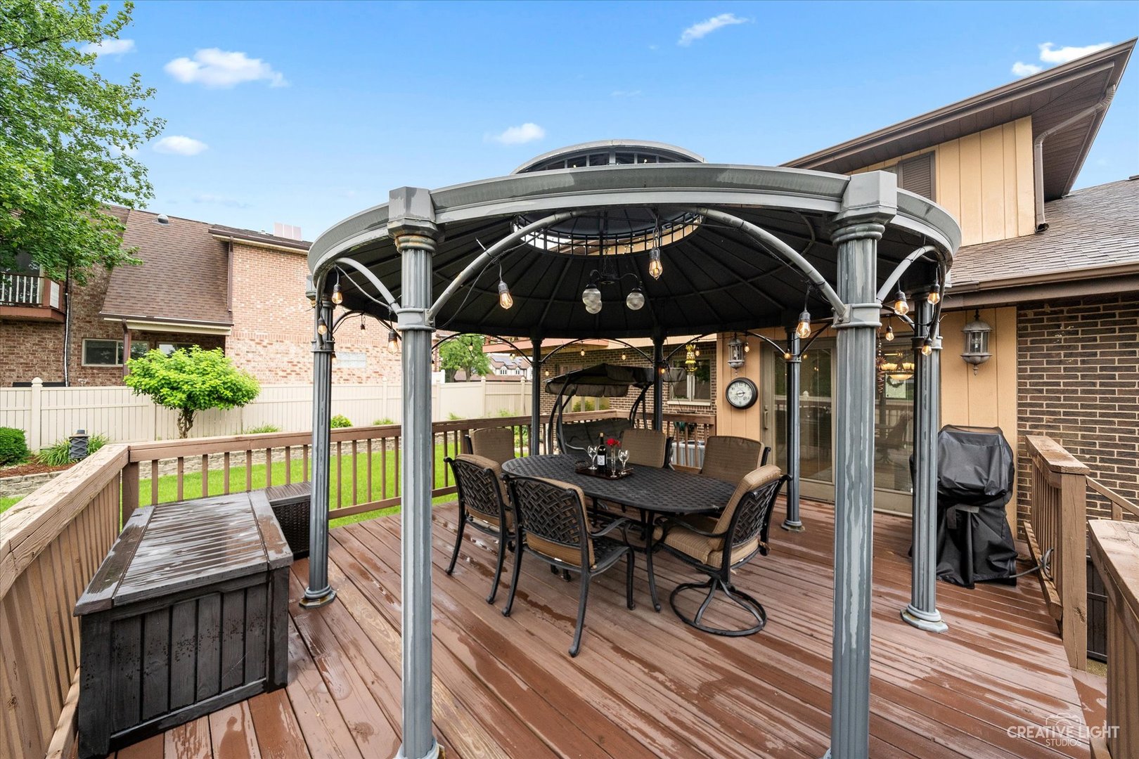 1130 Thatcher Lane Addison, IL 60101 - Photo 31 of 35 a view of a roof deck with table and chairs a barbeque with wooden floor and fence