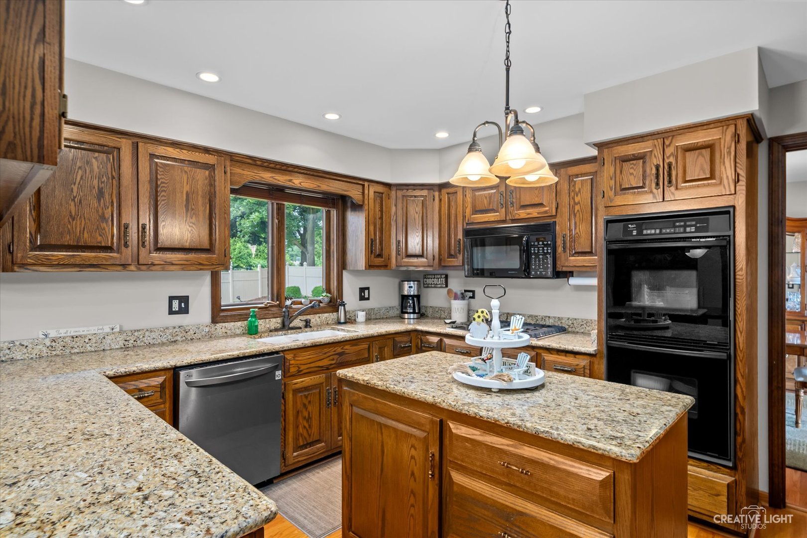 1130 Thatcher Lane Addison, IL 60101 - Photo 4 of 35 a kitchen with a sink dishwasher a stove and a kitchen island