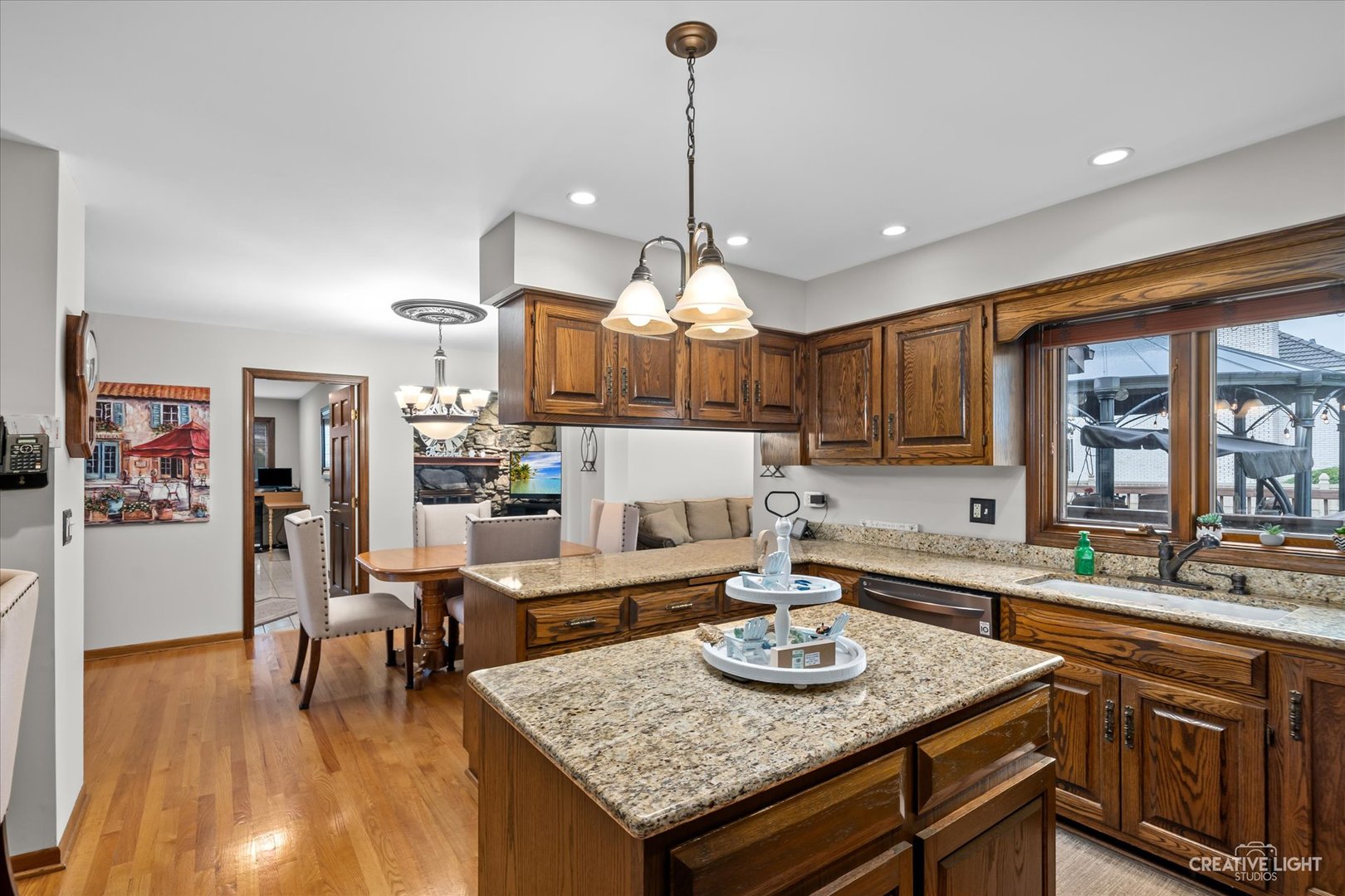 1130 Thatcher Lane Addison, IL 60101 - Photo 5 of 35 a kitchen with granite countertop a stove a sink a refrigerator dining table and chairs