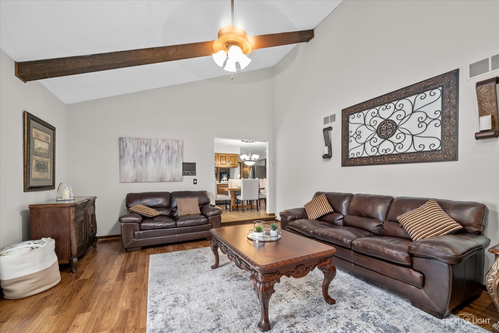 1130 Thatcher Lane Addison, IL 60101 - Photo 10 of 35 a living room with furniture a table and a painting
