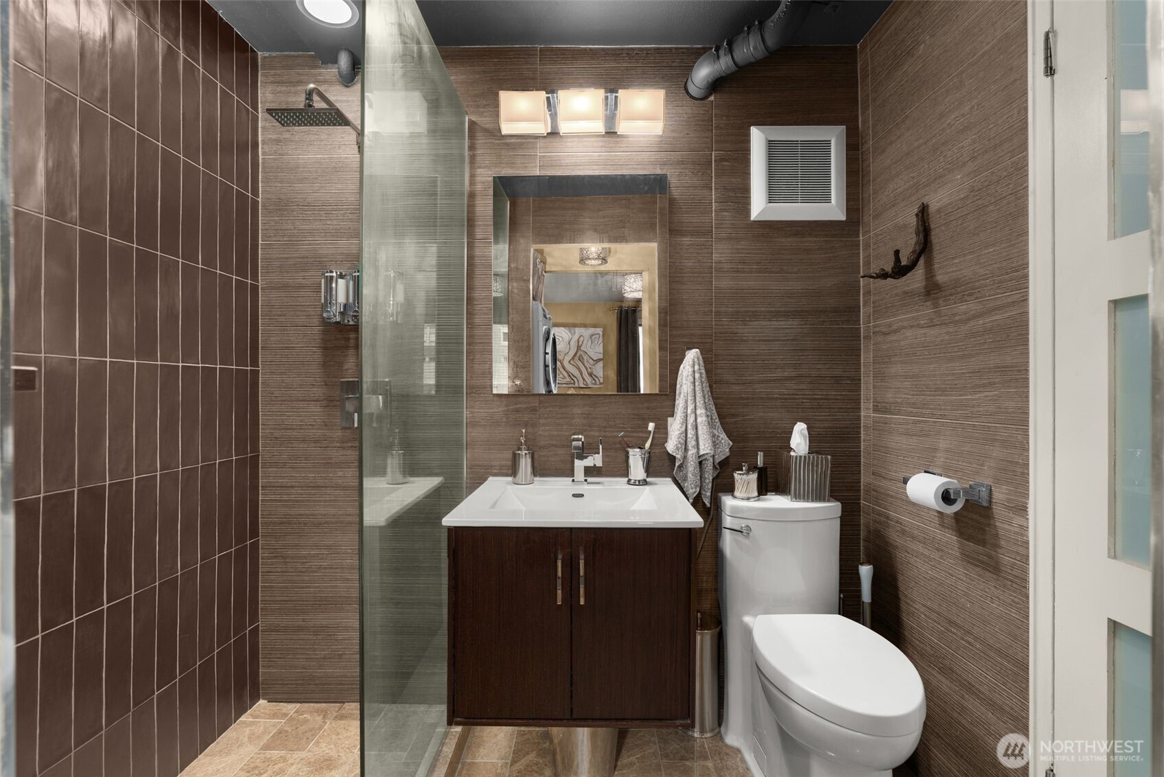 1105 Spring Street, Unit 211 Seattle, WA 98104 - Photo 18 of 26 a bathroom with a sink toilet and shower