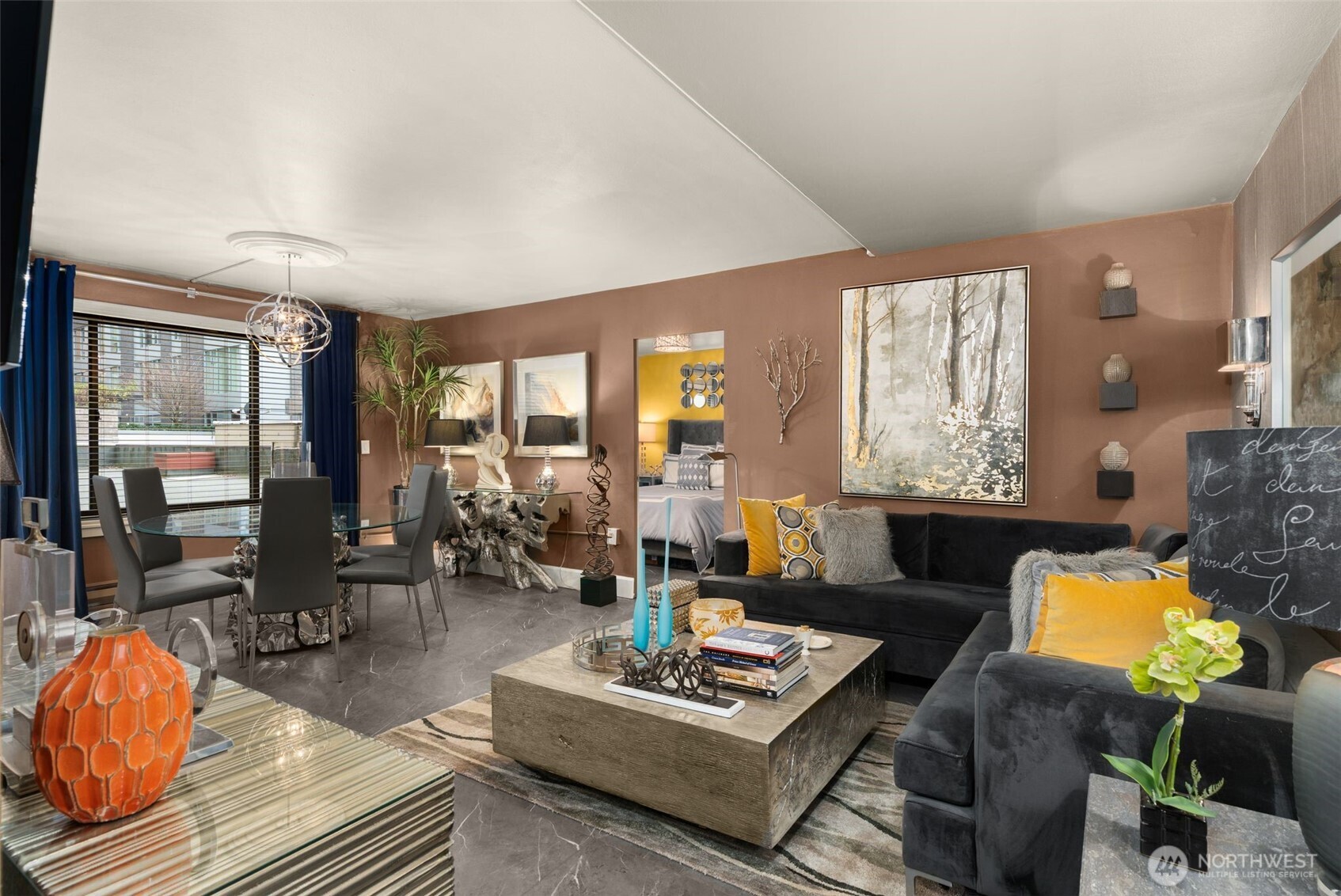1105 Spring Street, Unit 211 Seattle, WA 98104 - Photo 5 of 26 a living room with furniture and floor to ceiling windows