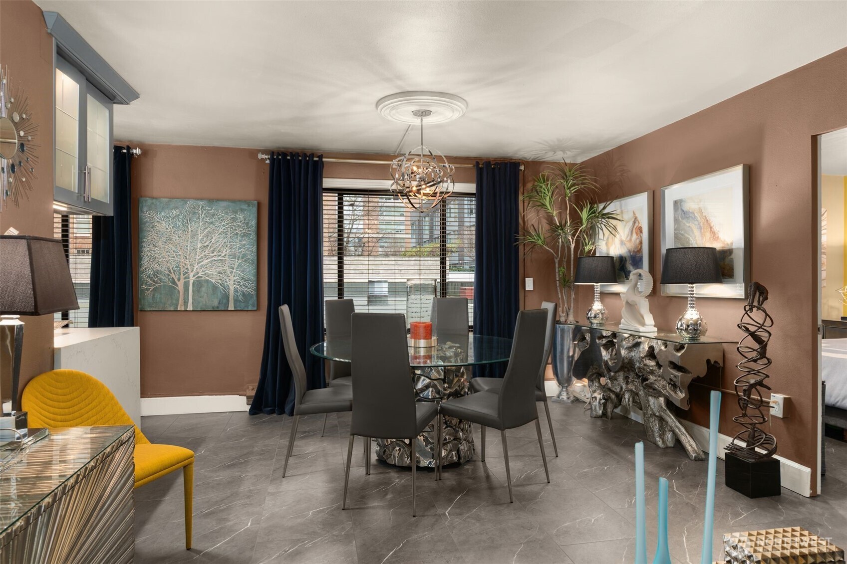 1105 Spring Street, Unit 211 Seattle, WA 98104 - Photo 7 of 26 a living room with furniture a rug and a chandelier