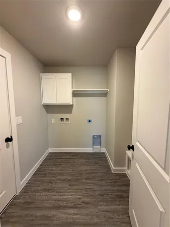 a view of a room with wooden floor and white walls